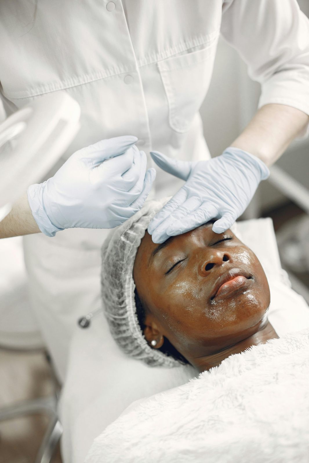 An aesthetic doctor giving a facial treatment